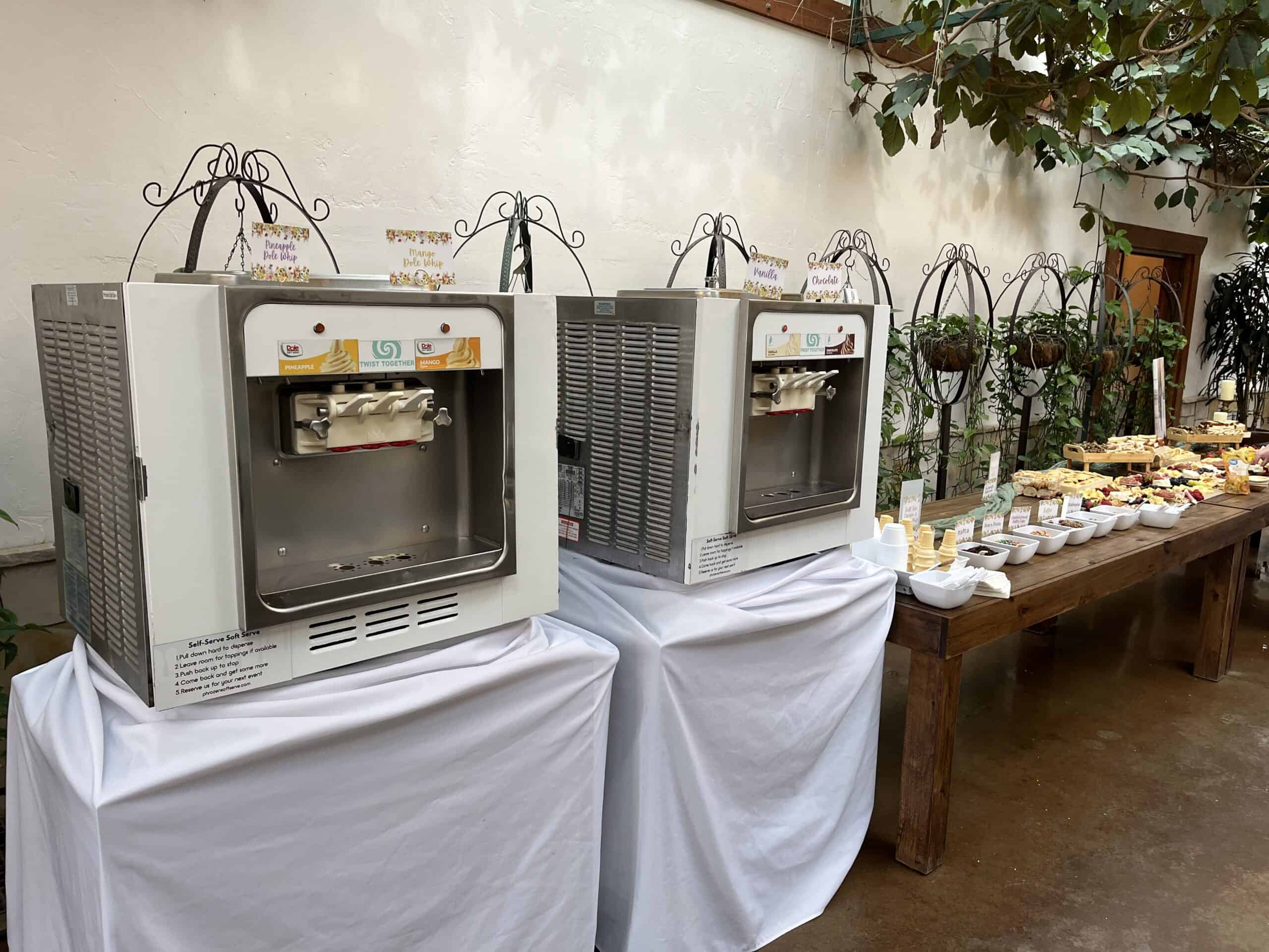 Two soft serve machines with Dole Soft Serve flavor cards beside a dessert table at Highland Gardens in American Fork